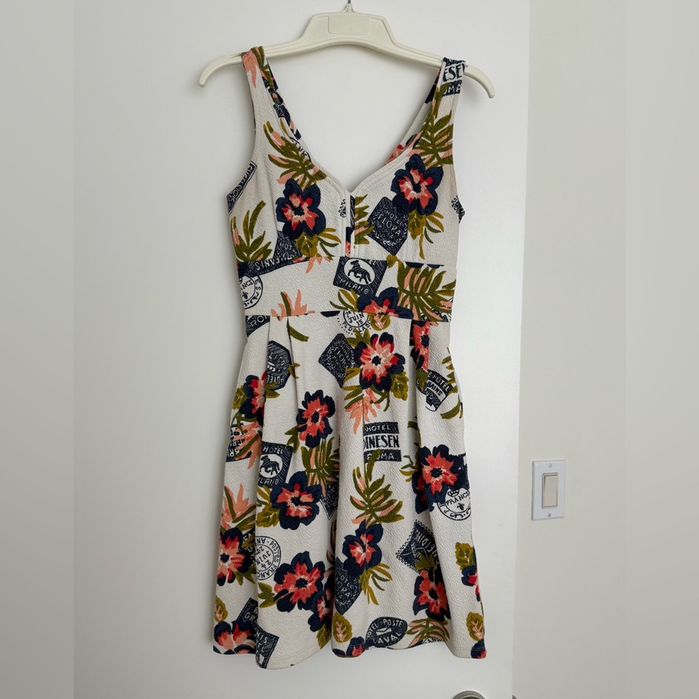 Floral V-Neck A-Line Dress in Cream with fun travel themed images.